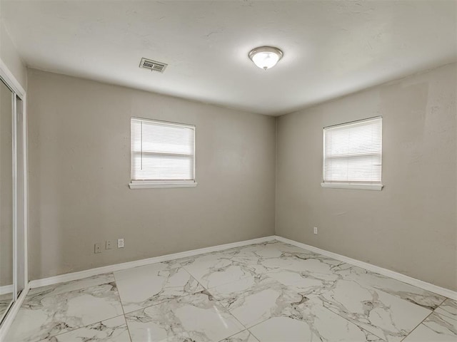 2837 SW 63rd St, Oklahoma City, OK 73159 - spare room with plenty of natural light and marble finish flooring