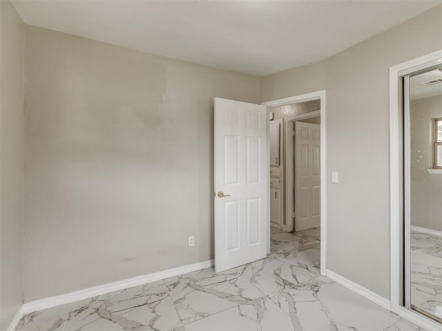 2837 SW 63rd St, Oklahoma City, OK 73159 - unfurnished bedroom featuring light marble finish floors and baseboards