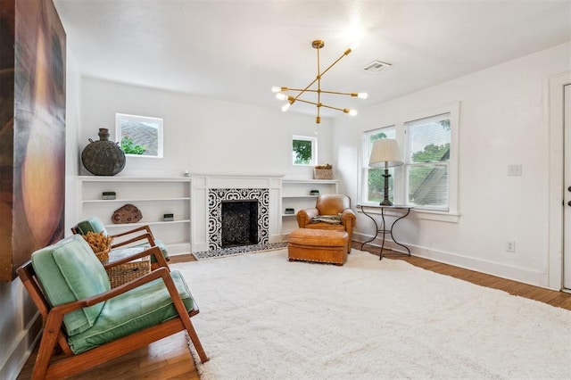 1828 NW 40th St, Oklahoma City, OK 73118 - living area featuring wood finished floors, a fireplace, and a chandelier