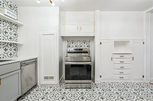 1828 NW 40th St, Oklahoma City, OK 73118 - kitchen with appliances with stainless steel finishes, open shelves, light tile patterned flooring, gray cabinetry, and light stone countertops
