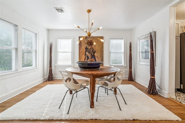 1828 NW 40th St, Oklahoma City, OK 73118 - dining area featuring a chandelier and light wood-type flooring