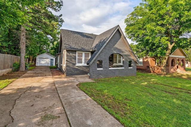 1828 NW 40th St, Oklahoma City, OK 73118 - tudor-style house featuring brick siding, driveway, an outbuilding, a garage, and a shingled roof