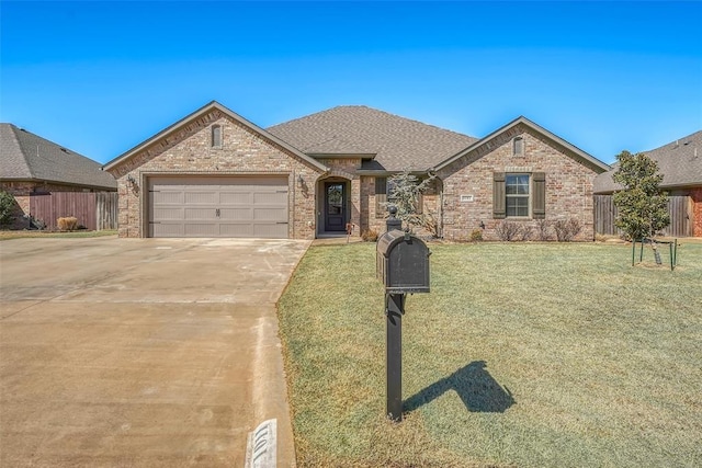 1101 Northridge Blvd, Altus, OK 73521 - french country home with concrete driveway, brick siding, a garage, and roof with shingles