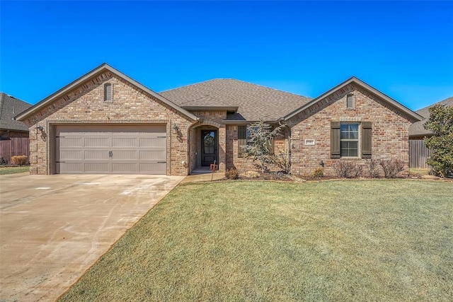 1101 Northridge Blvd, Altus, OK 73521 - french provincial home with concrete driveway, a garage, brick siding, and roof with shingles