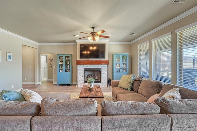 1101 Northridge Blvd, Altus, OK 73521 - living area featuring a ceiling fan, light wood-type flooring, a fireplace, and ornamental molding