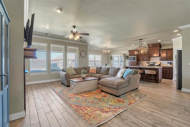 1101 Northridge Blvd, Altus, OK 73521 - living room with ceiling fan, light wood-type flooring, recessed lighting, ornamental molding, and a chandelier