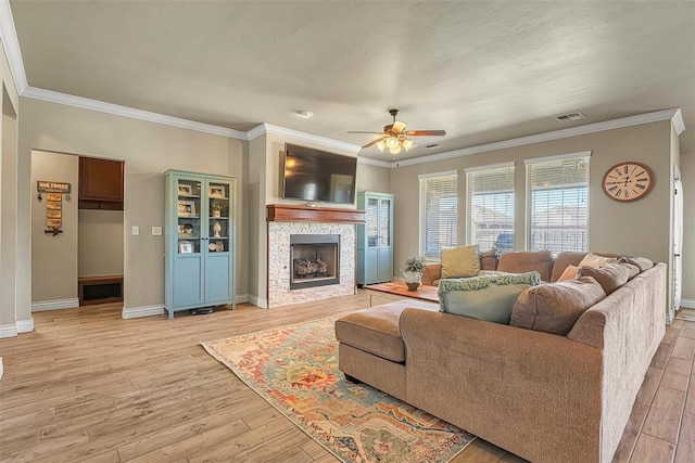 1101 Northridge Blvd, Altus, OK 73521 - living room with light wood-style floors, ceiling fan, crown molding, and a stone fireplace