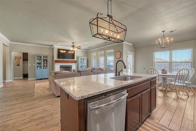 1101 Northridge Blvd, Altus, OK 73521 - kitchen featuring dishwasher, a chandelier, a fireplace, ornamental molding, and light wood-style flooring