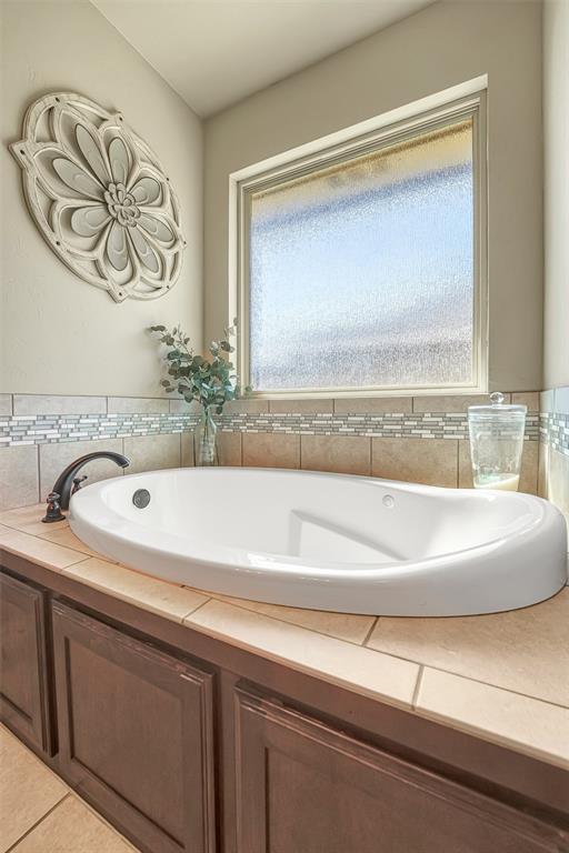 1101 Northridge Blvd, Altus, OK 73521 - bathroom with a garden tub and tile patterned flooring