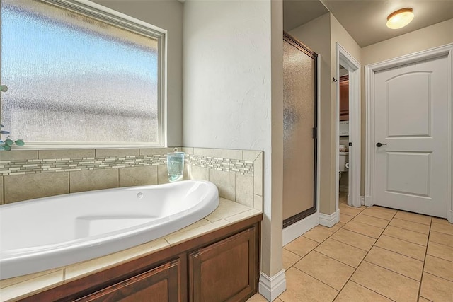 1101 Northridge Blvd, Altus, OK 73521 - full bath featuring a shower stall, tile patterned flooring, and a bath