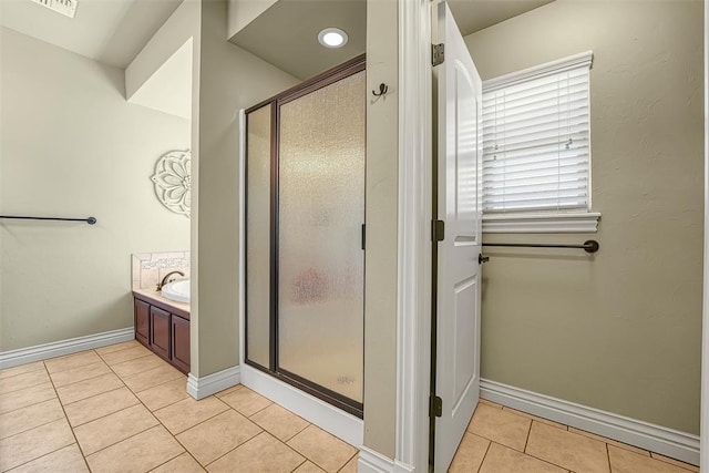 1101 Northridge Blvd, Altus, OK 73521 - bathroom featuring tile patterned floors, a stall shower, and vanity