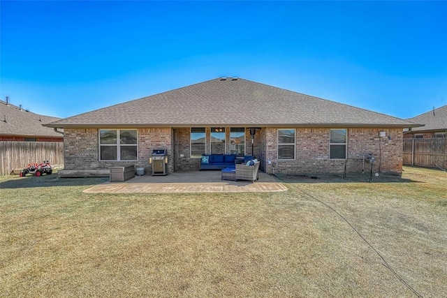 1101 Northridge Blvd, Altus, OK 73521 - rear view of house featuring an outdoor living space, a patio area, brick siding, and a shingled roof