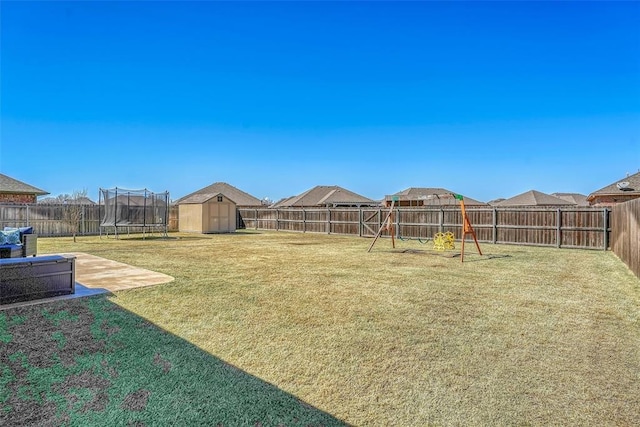 1101 Northridge Blvd, Altus, OK 73521 - fenced backyard featuring a storage shed, a trampoline, and a patio area
