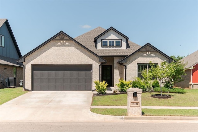 16101 Villa Valeria Way, Edmond, OK 73013 - view of front facade with a garage, a front yard, concrete driveway, and roof with shingles