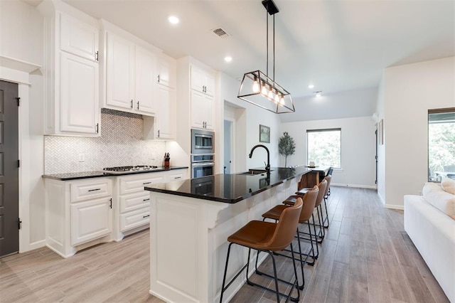 16101 Villa Valeria Way, Edmond, OK 73013 - kitchen featuring stainless steel appliances, light wood-style floors, tasteful backsplash, plenty of natural light, and recessed lighting