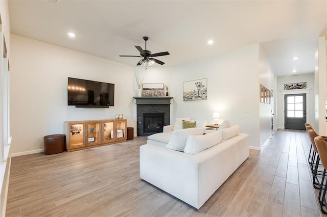 16101 Villa Valeria Way, Edmond, OK 73013 - living room with light wood-style flooring, ceiling fan, a glass covered fireplace, and recessed lighting