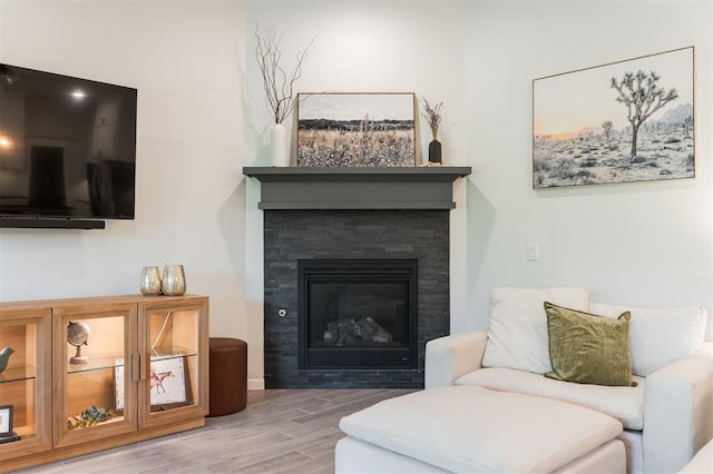 16101 Villa Valeria Way, Edmond, OK 73013 - sitting room featuring wood finished floors and a glass covered fireplace