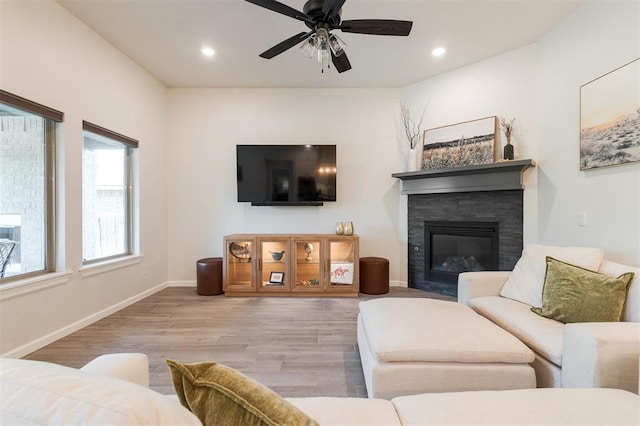 16101 Villa Valeria Way, Edmond, OK 73013 - living room with wood finished floors, ceiling fan, a stone fireplace, and recessed lighting