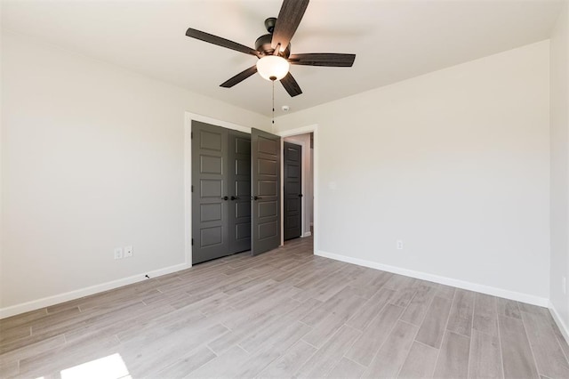 16101 Villa Valeria Way, Edmond, OK 73013 - unfurnished bedroom with light wood-type flooring, ceiling fan, and a closet