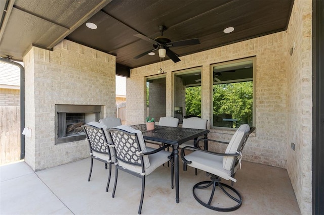 16101 Villa Valeria Way, Edmond, OK 73013 - view of patio / terrace with an outdoor brick fireplace, ceiling fan, and outdoor dining space