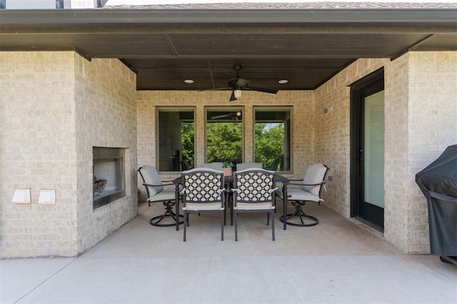 16101 Villa Valeria Way, Edmond, OK 73013 - view of patio / terrace featuring a fireplace, outdoor dining area, and ceiling fan