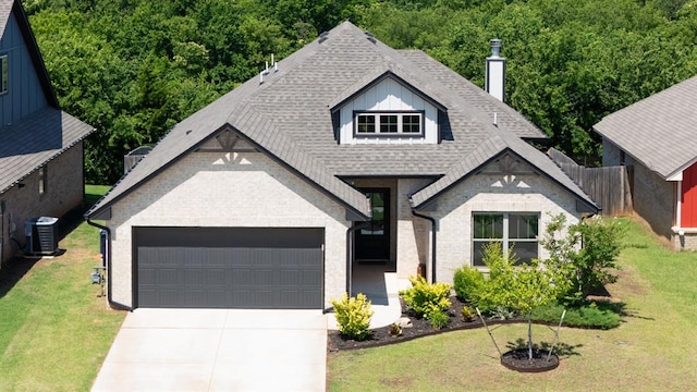 16101 Villa Valeria Way, Edmond, OK 73013 - view of front facade with a garage, driveway, roof with shingles, and a front lawn