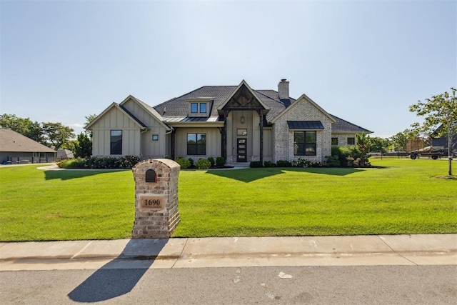 1690 Shaylee Ln, Choctaw, OK 73020 - view of front of house with board and batten siding, a front yard, a chimney, and a standing seam roof