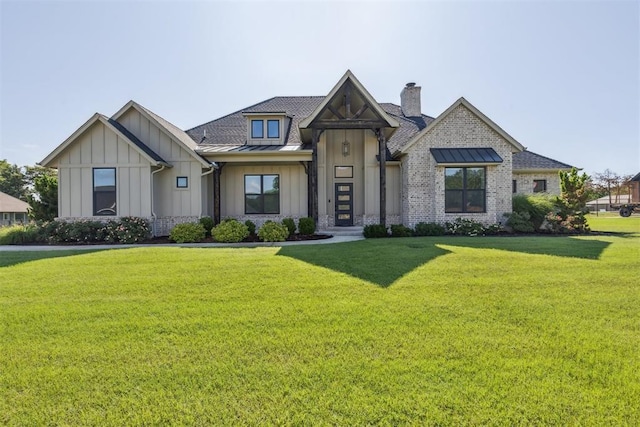 1690 Shaylee Ln, Choctaw, OK 73020 - view of front of house featuring board and batten siding, a front lawn, and a standing seam roof