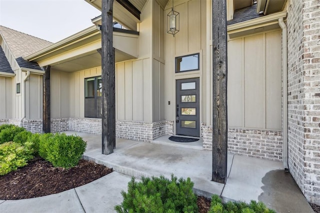1690 Shaylee Ln, Choctaw, OK 73020 - doorway to property with board and batten siding, covered porch, and roof with shingles