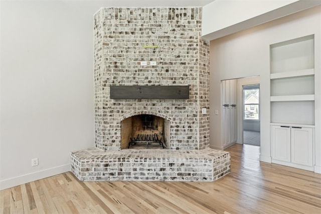 1690 Shaylee Ln, Choctaw, OK 73020 - unfurnished living room with a brick fireplace and wood finished floors