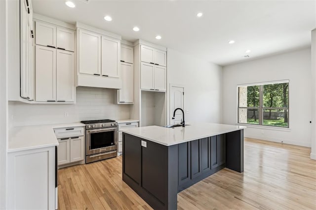 1690 Shaylee Ln, Choctaw, OK 73020 - kitchen with stainless steel stove, light wood-type flooring, light countertops, recessed lighting, and tasteful backsplash