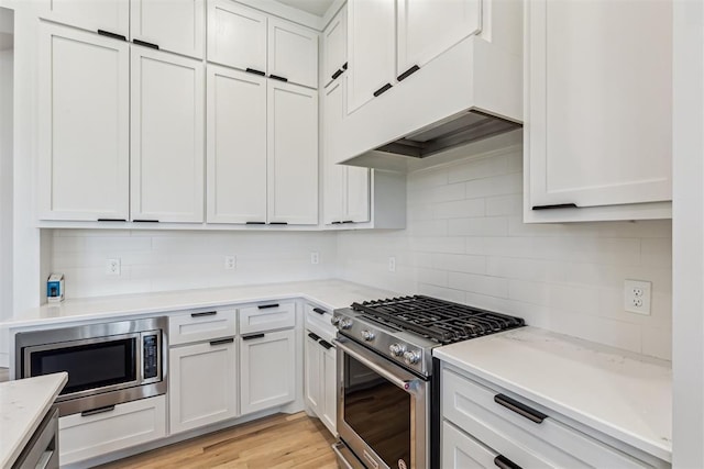 1690 Shaylee Ln, Choctaw, OK 73020 - kitchen with appliances with stainless steel finishes, decorative backsplash, light countertops, and custom range hood