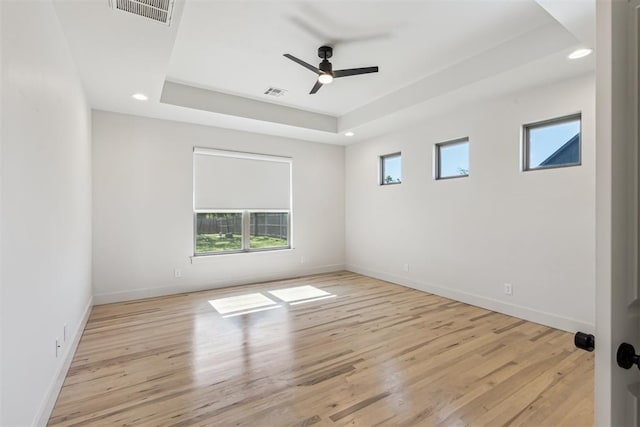 1690 Shaylee Ln, Choctaw, OK 73020 - empty room with a raised ceiling, a ceiling fan, light wood-style floors, and recessed lighting