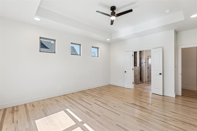 1690 Shaylee Ln, Choctaw, OK 73020 - unfurnished bedroom featuring a raised ceiling, recessed lighting, light wood-style floors, and ceiling fan
