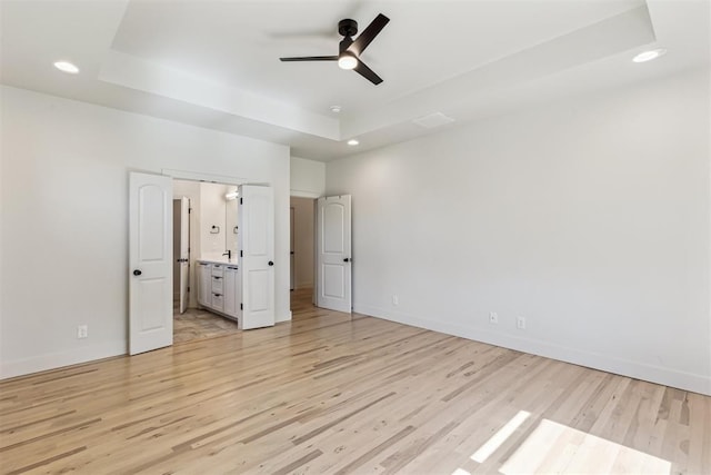 1690 Shaylee Ln, Choctaw, OK 73020 - unfurnished bedroom with a raised ceiling, light wood-style flooring, recessed lighting, and ceiling fan