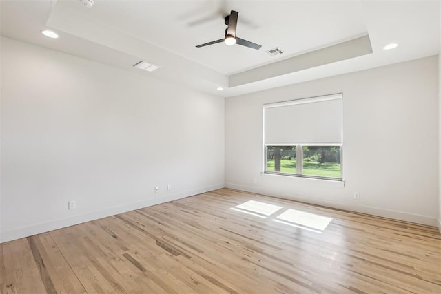 1690 Shaylee Ln, Choctaw, OK 73020 - unfurnished room with a raised ceiling, recessed lighting, ceiling fan, and wood finished floors