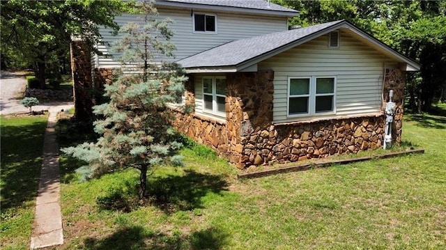 14500 Billy Dr, Edmond, OK 73034 - view of side of property with roof with shingles, stone siding, and a lawn
