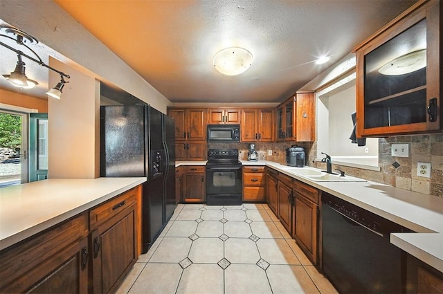 14500 Billy Dr, Edmond, OK 73034 - kitchen featuring black appliances, decorative backsplash, light countertops, and glass insert cabinets