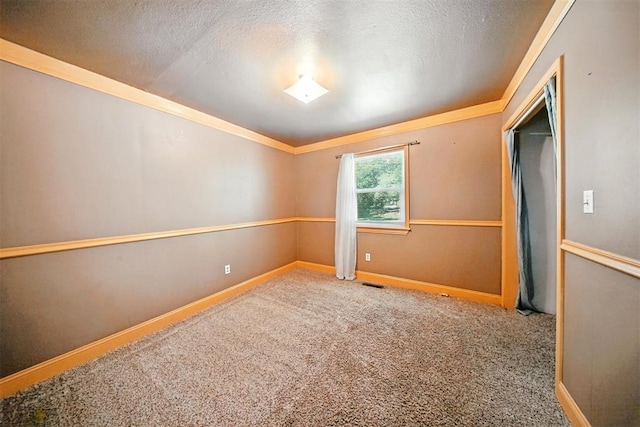14500 Billy Dr, Edmond, OK 73034 - unfurnished bedroom featuring ornamental molding, a textured ceiling, and carpet flooring
