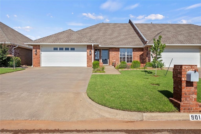 901 Gartrell Pl, Weatherford, OK 73096 - view of front facade featuring a garage, concrete driveway, a front yard, and brick siding