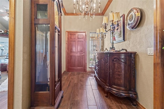 901 Gartrell Pl, Weatherford, OK 73096 - entrance foyer featuring a textured wall, crown molding, dark wood finished floors, and a chandelier