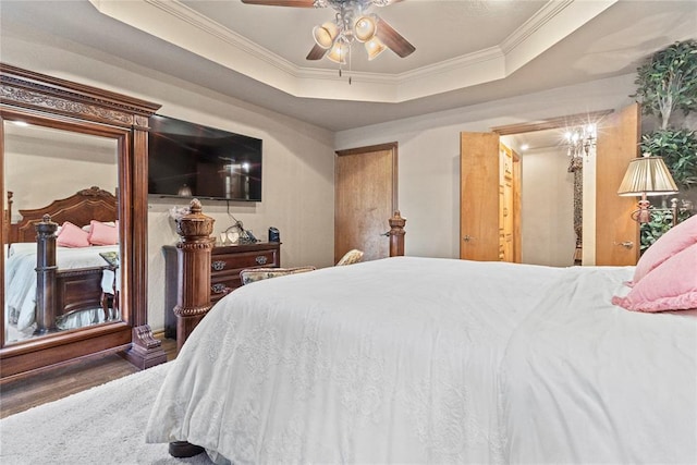 901 Gartrell Pl, Weatherford, OK 73096 - bedroom with wood finished floors, crown molding, a raised ceiling, and a ceiling fan