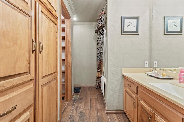 901 Gartrell Pl, Weatherford, OK 73096 - bathroom with vanity, wood finished floors, a textured wall, and ornamental molding