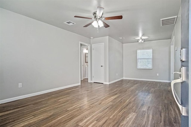 909 Buck Dr, Shawnee, OK 74801 - spare room featuring a ceiling fan and dark wood-style flooring