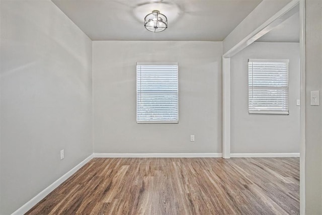 909 Buck Dr, Shawnee, OK 74801 - spare room with wood finished floors and baseboards