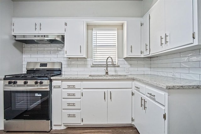 909 Buck Dr, Shawnee, OK 74801 - kitchen featuring stainless steel gas stove, under cabinet range hood, white cabinets, tasteful backsplash, and dark wood-type flooring