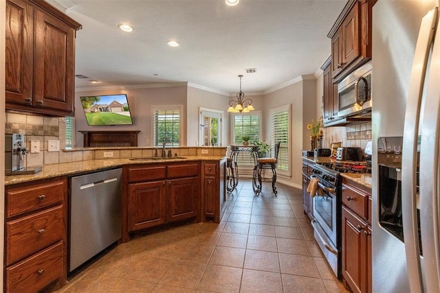 1106 Prairie Dunes Ct, Norman, OK 73072 - kitchen with stainless steel appliances, decorative backsplash, a peninsula, light tile patterned floors, and recessed lighting