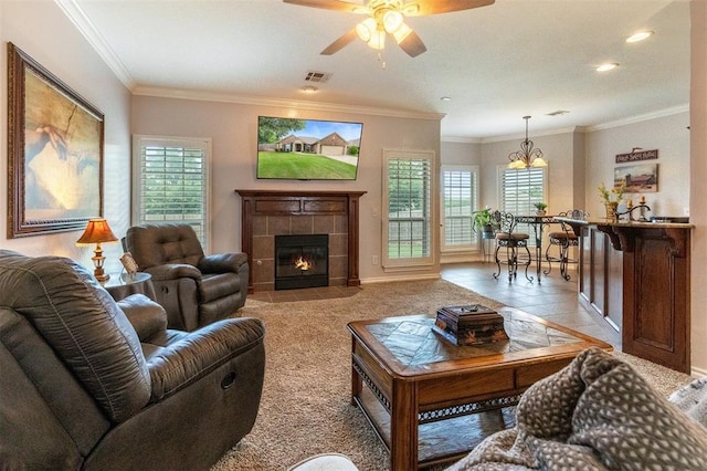 1106 Prairie Dunes Ct, Norman, OK 73072 - living room featuring a ceiling fan, ornamental molding, a fireplace, and light colored carpet