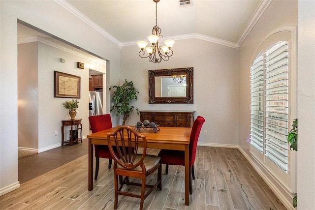 1106 Prairie Dunes Ct, Norman, OK 73072 - dining room featuring light wood-style flooring, a chandelier, and crown molding