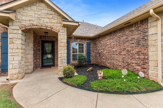 1106 Prairie Dunes Ct, Norman, OK 73072 - doorway to property featuring stone siding, a shingled roof, and brick siding